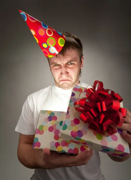 Сумний день народження чоловік відкриває подарункову коробку — стокове фото
