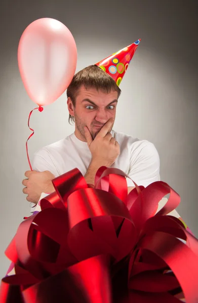 Birthday man looking big gift box — Stock Photo, Image