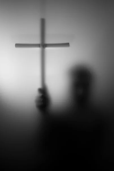 Silhouette of saint with cross — Stock Photo, Image
