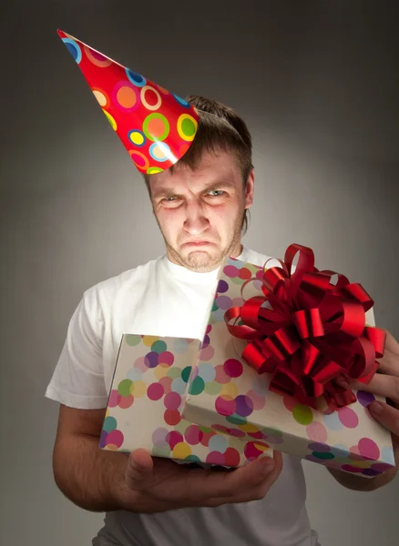 Sad birthday man opening gift box Royalty Free Stock Photos