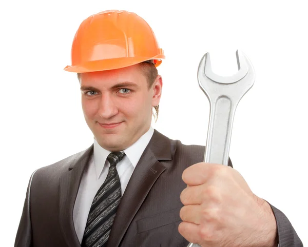 Smiling engineer in hardhat with spanner — Stock Photo, Image
