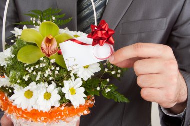 Happy businessman with basket of flowers clipart