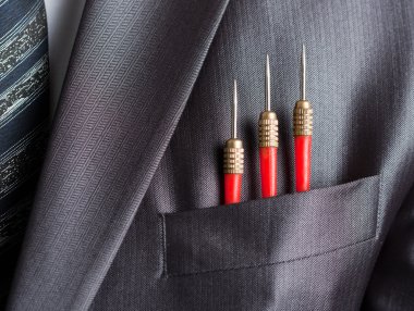 Three red darts in businessman suit pocket clipart