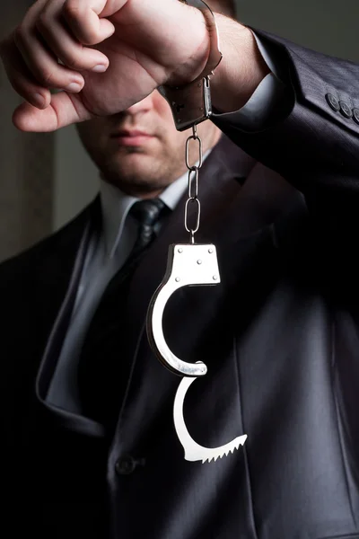 Businessman with unlocked handcuffs — Stock Photo, Image
