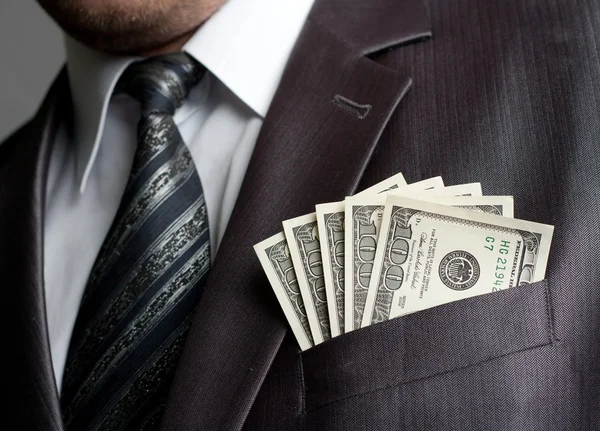 Businessman with money in suit pocket — Stock Photo, Image