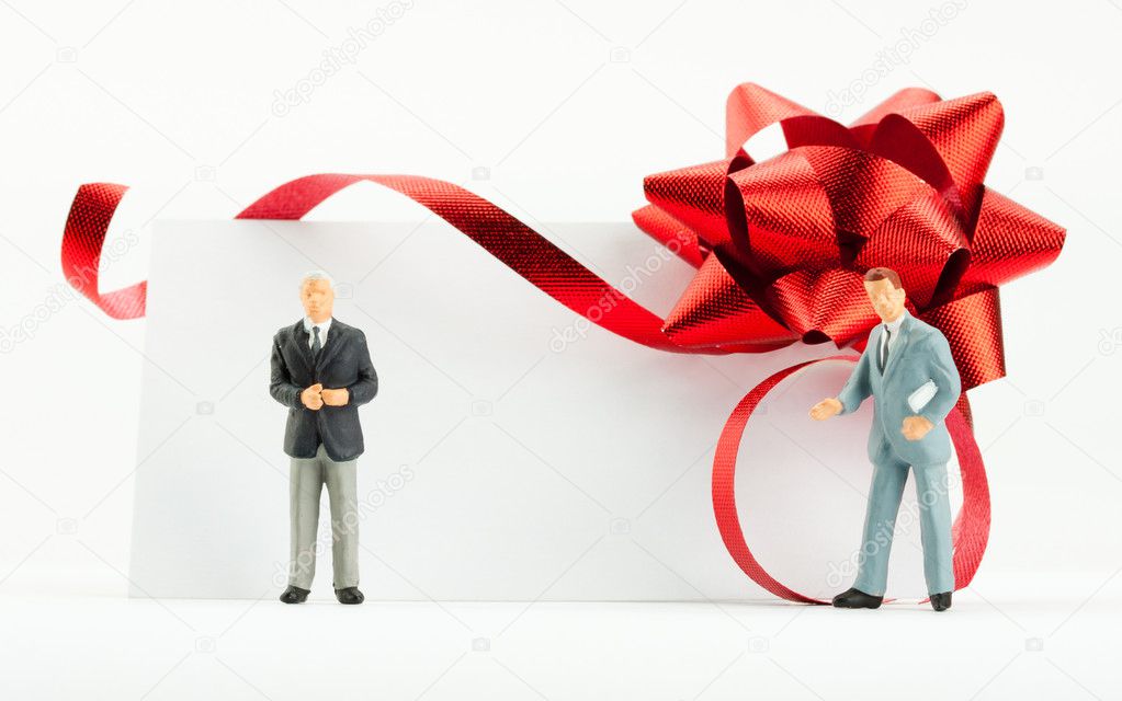 Figurines of businessmen with gift card
