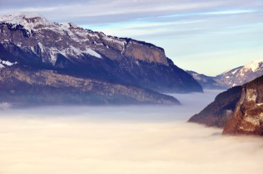 View over a valley of clouds filling clipart