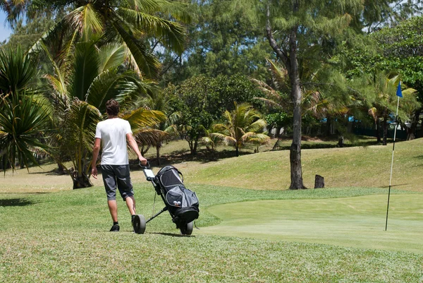 Golf oynayan genç adam.