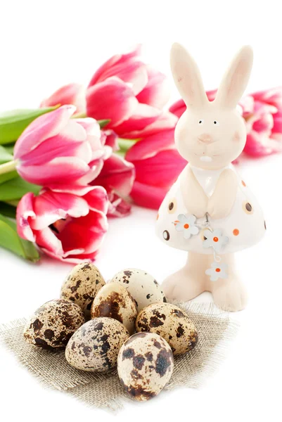 Пасхальный кролик с перепелиными яйцами и тюльпанами — стоковое фото