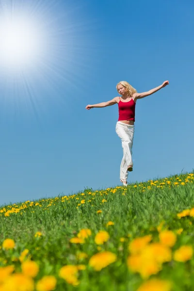 Young woman in red outfit having fun on meadow — Stock Photo, Image