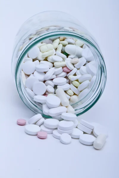 Pills in glass container — Stock Photo, Image