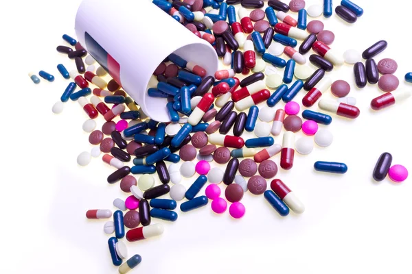 Pills spilling out of container — Stock Photo, Image