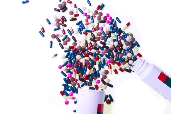 Pills spilling out of container — Stock Photo, Image