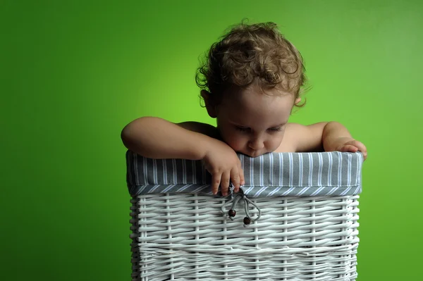 Baby sitting in a basket — Stock Photo, Image