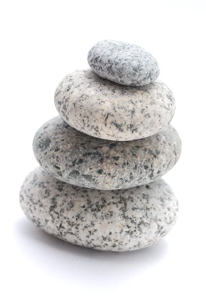 Four pebble sculpture on a white background — Stock Photo, Image