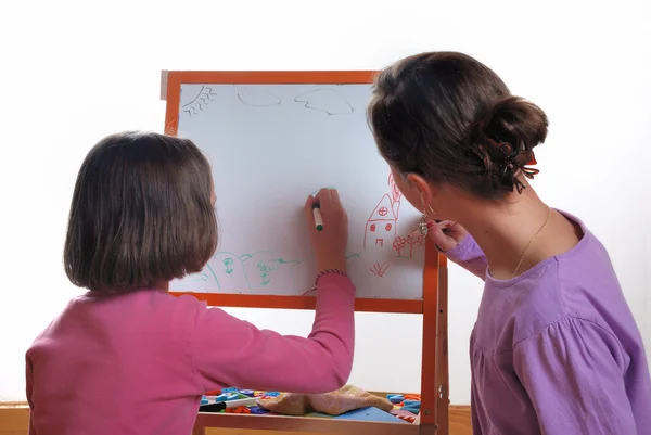 Youngs girls drawing on the white board — Stock Photo, Image