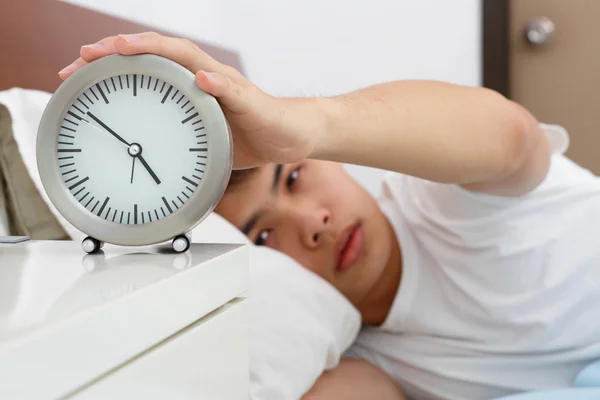 Sleepy Asian Man Switching His Alarm Clock — Stock Photo, Image