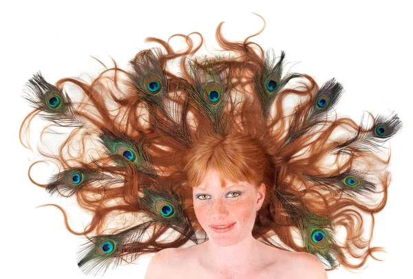 stock image Pretty red-head woman with peacock feathers in her hair