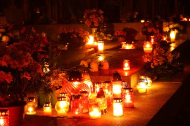 Candles burning at a cemetery clipart