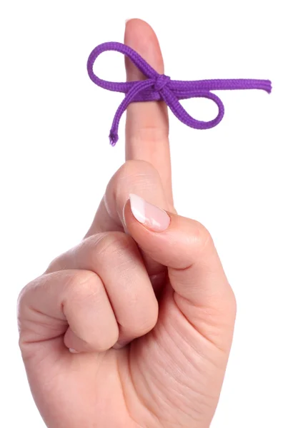 A finger contains a bow-tied string as a reminder — Stock Photo, Image