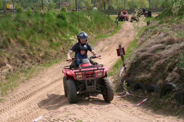 Dad with son riding a quad clipart