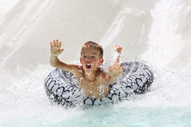 Boy having fun in water park clipart