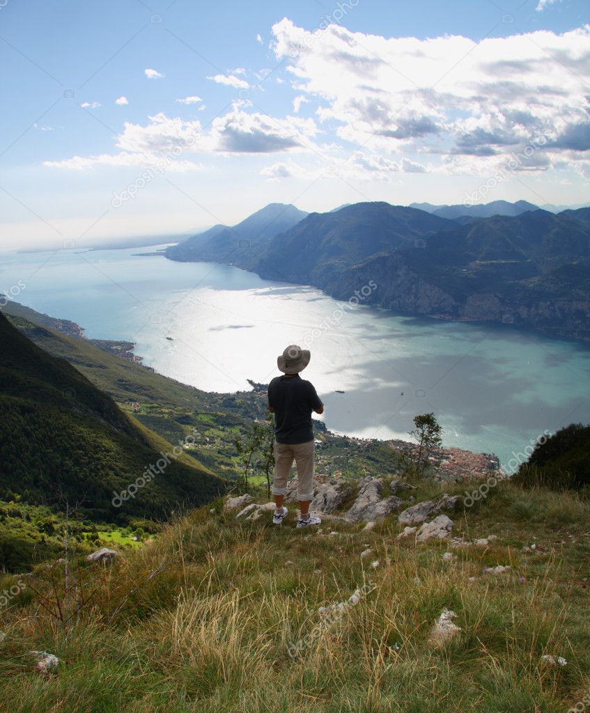Alone man overview Lake Garda with Monte Baldo