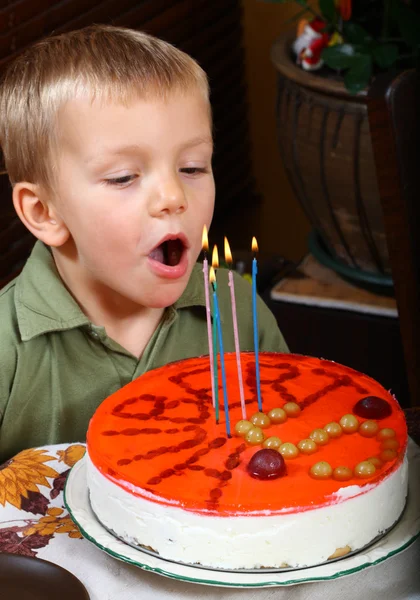 stock image Young boy is blowing candles