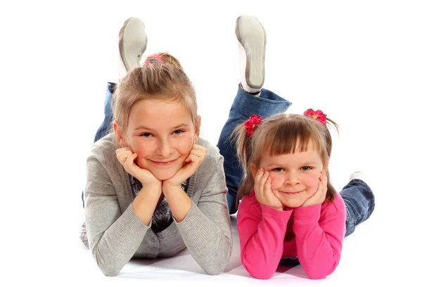 Two young sisters posing together in a studio — Stock Photo, Image