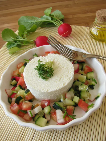 Goat cream cheese on vegetable salad with radishes — Stock Photo, Image