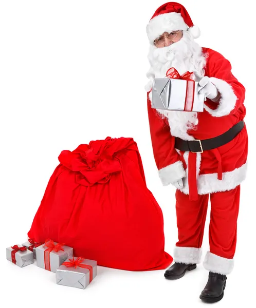 Santa claus gives a present — Stock Photo, Image