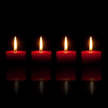 Four red candles, black background clipart