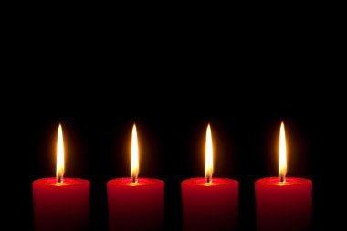 Four red candles, black background clipart