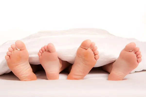 stock image Close-up of feet of a young couple on bed