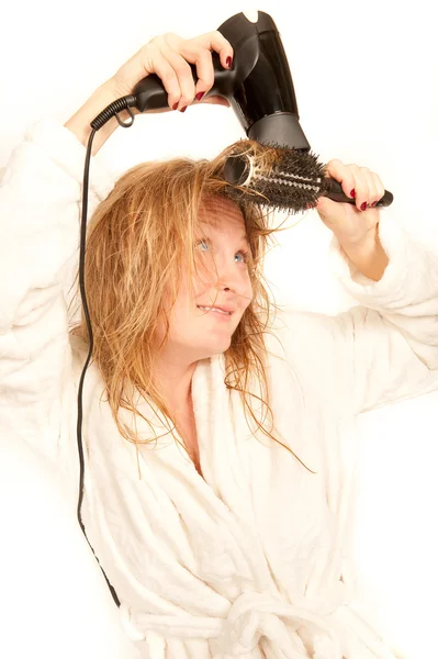 Young woman with hairdryer and brush — Stock Photo, Image