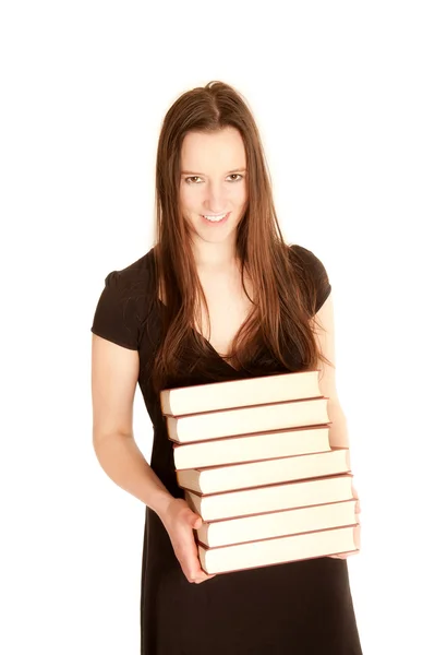 Jonge vrouw met een stapel boeken — Stockfoto