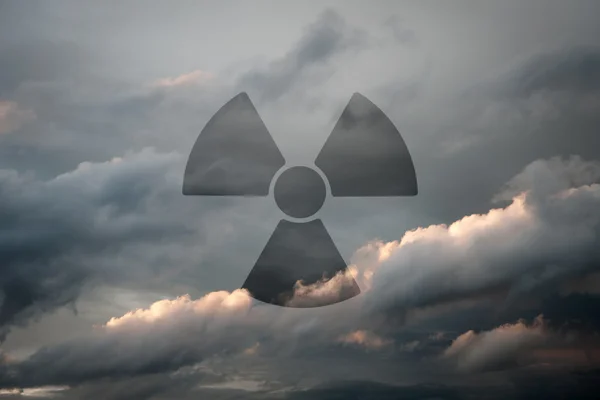 stock image Dramatic sky with symbol of radioactivity