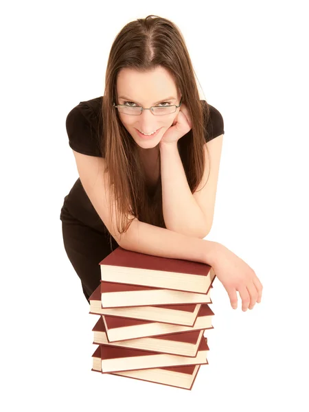 Młody student z okulary i stos książek — Zdjęcie stockowe