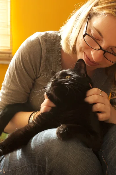 Frau umarmt Katze auf Schoß — Stockfoto