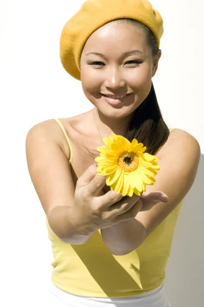 Closeup portrait of a girl with yellow flower — Stock Photo, Image