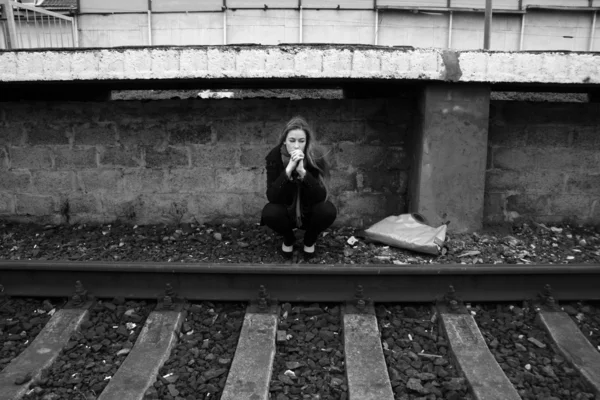 思いやりのある女の子の鉄道近くに座って — ストック写真