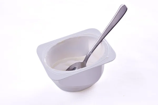 stock image Empty container of yoghurt with a tea spoon