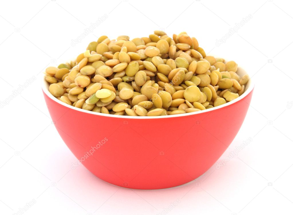 Close up view of cooked green lentil in red bowl on white backgroun