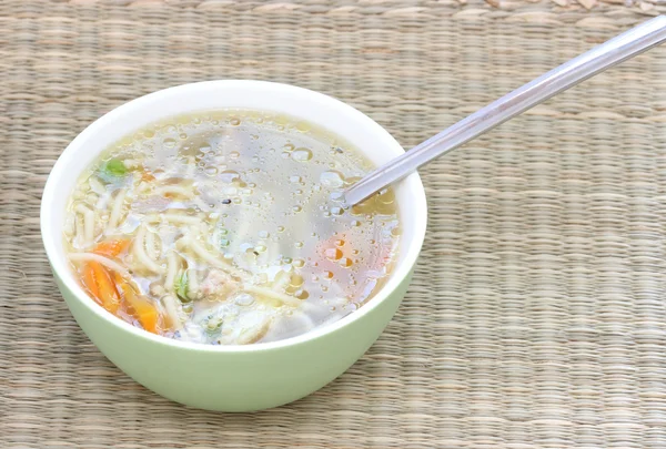 Broth soup with spoon and vegetable — Stock Photo, Image