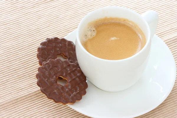 Chocolate biscuits on saucer with coffee — Stock Photo, Image