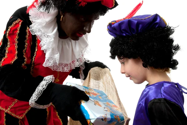 Zwarte Piet ( black pete) typical dutch character with young chi — Stock Photo, Image