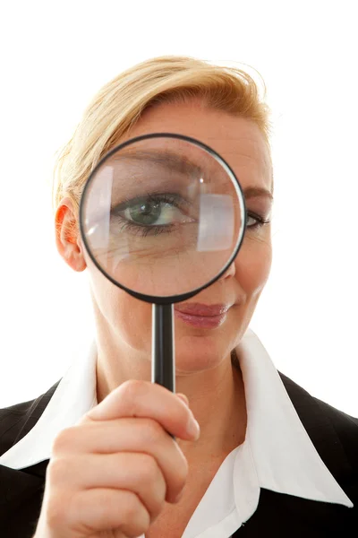Business woman with magnifying glass to the eye — Stock Photo, Image