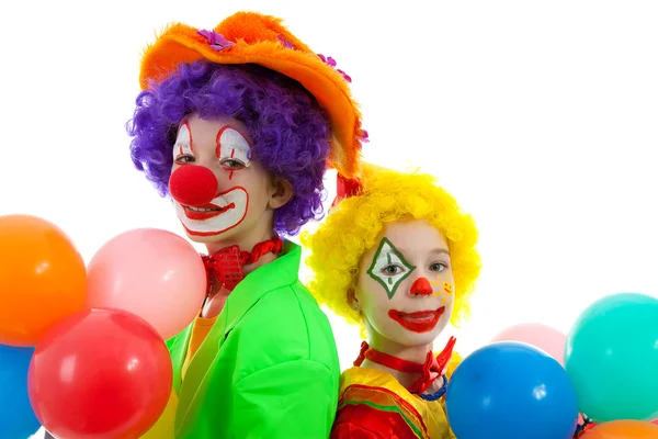 Portrait of two children dressed as colorful funny clowns — Stock Photo, Image