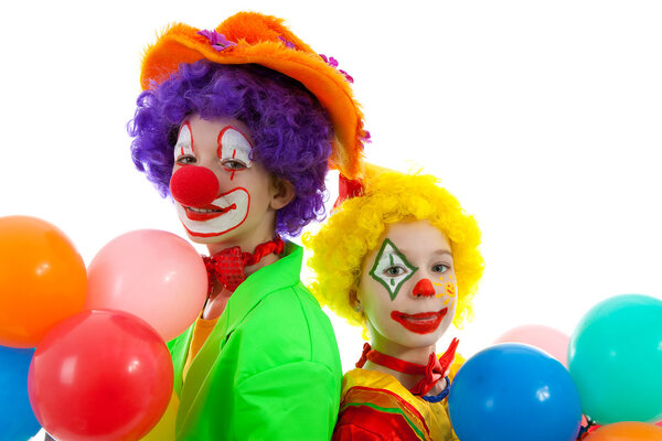 Portrait of two children dressed as colorful funny clowns