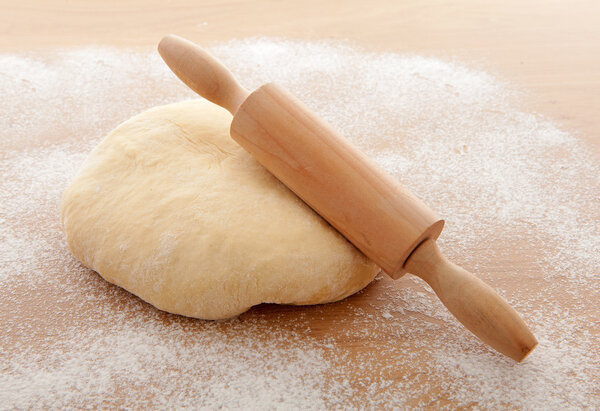 Pizza dough with rolling pin